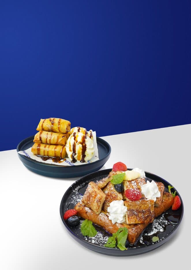 French toast with berries and cream beside banana frites with ice cream